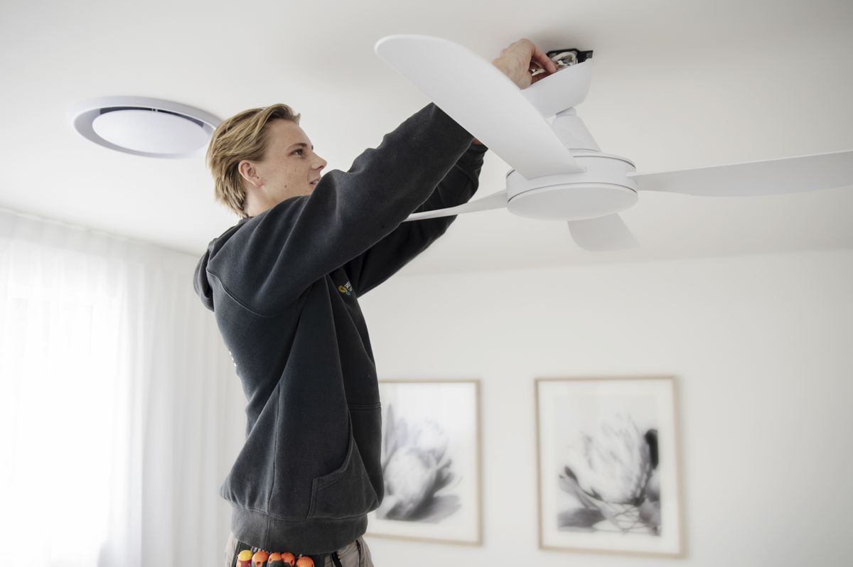 Gregg Hume electrician installing a ceiling fan